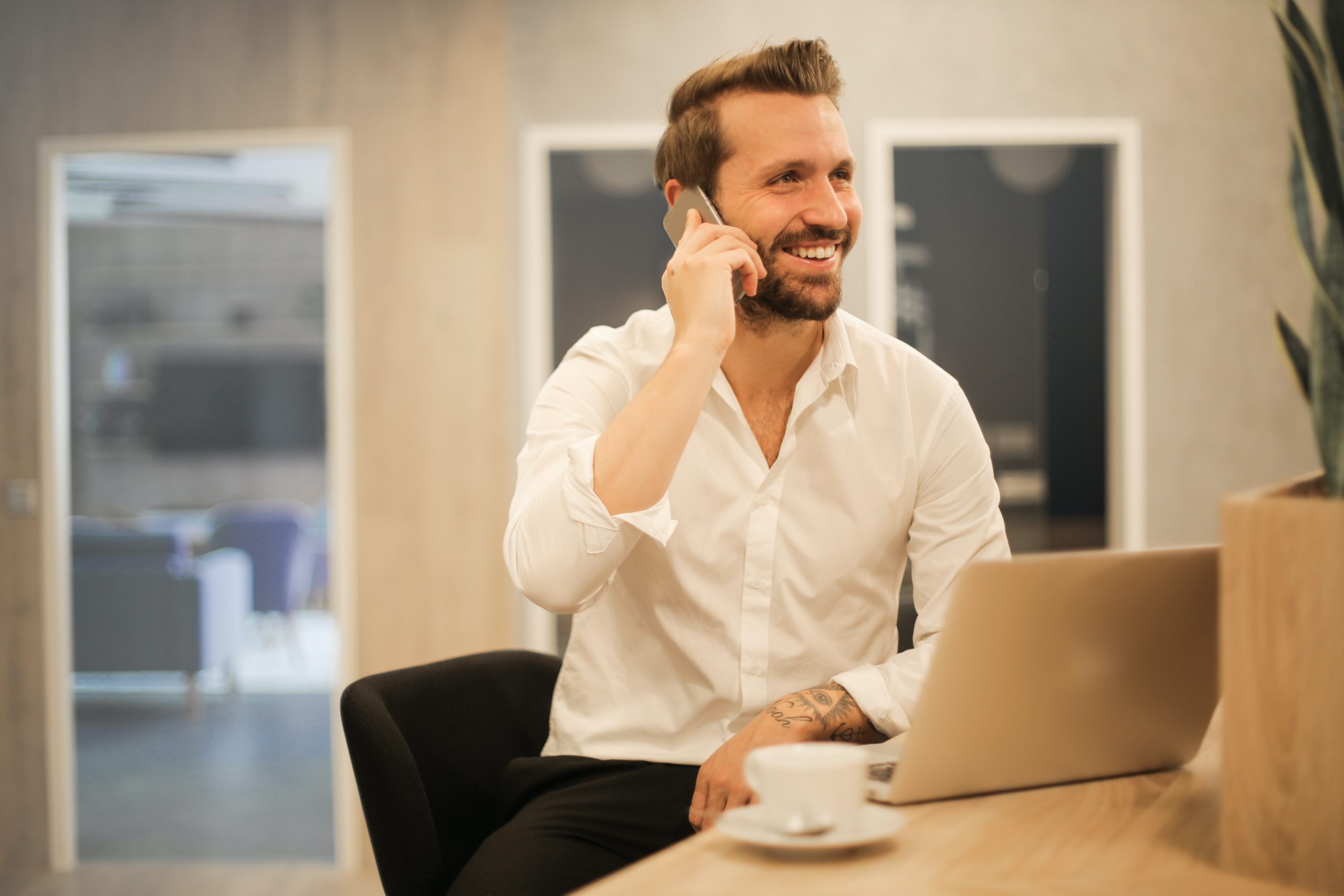 Image of a man smiling while calling on the phone for basix assessments